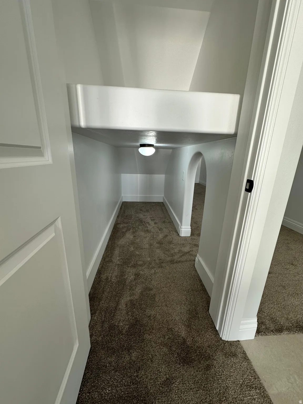 Detailed view of carpet flooring and baseboards
