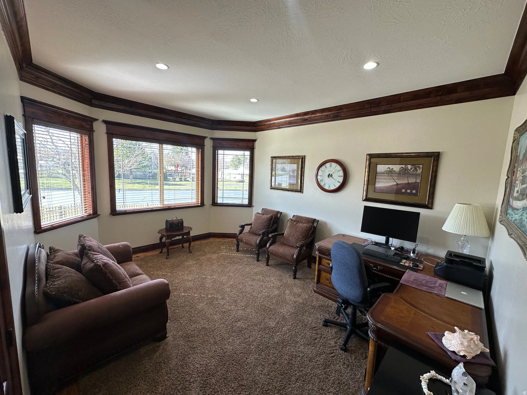 Carpeted office space featuring crown molding, recessed lighting, and a textured ceiling