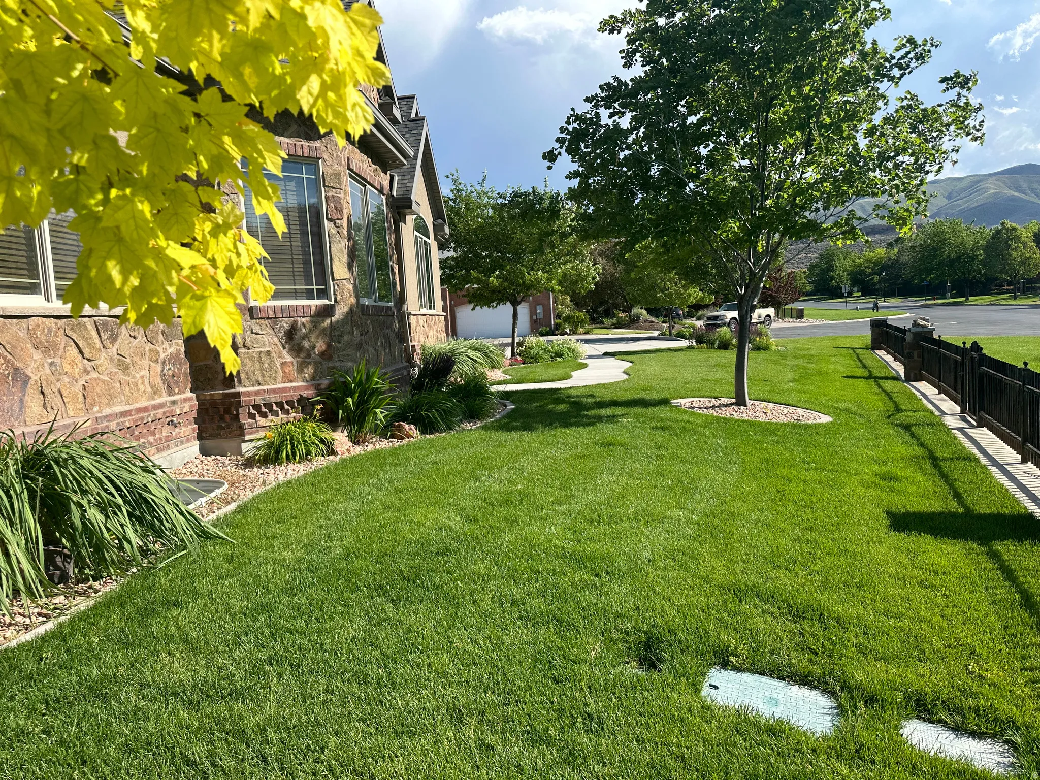 View of green lawn with a garage