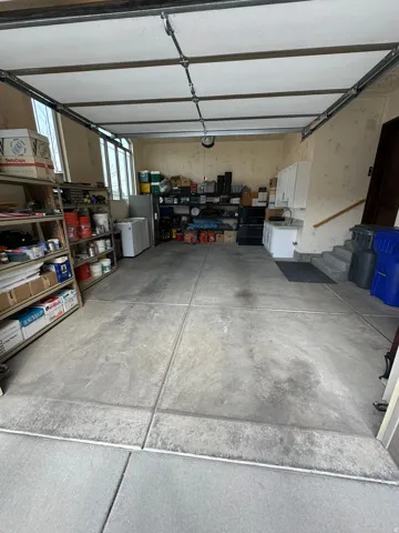 Garage featuring freestanding refrigerator