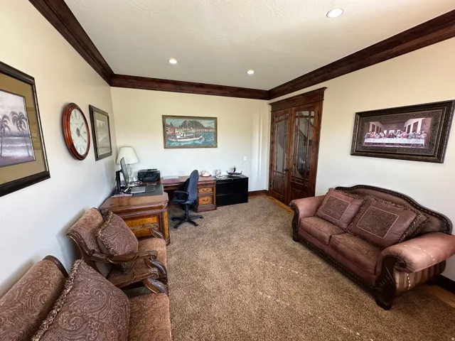 Carpeted home office with ornamental molding, french doors, and recessed lighting