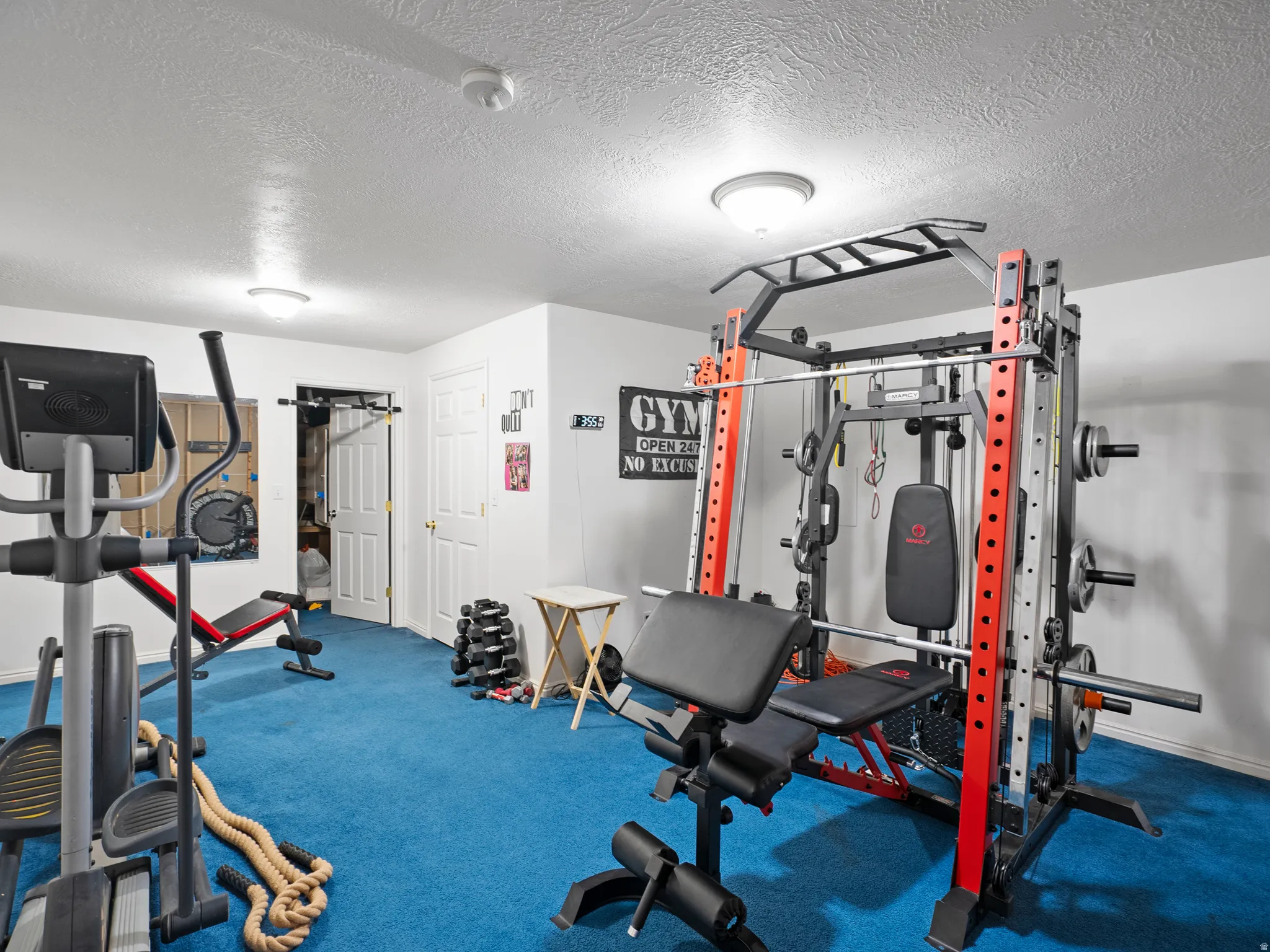 Exercise room with a textured ceiling