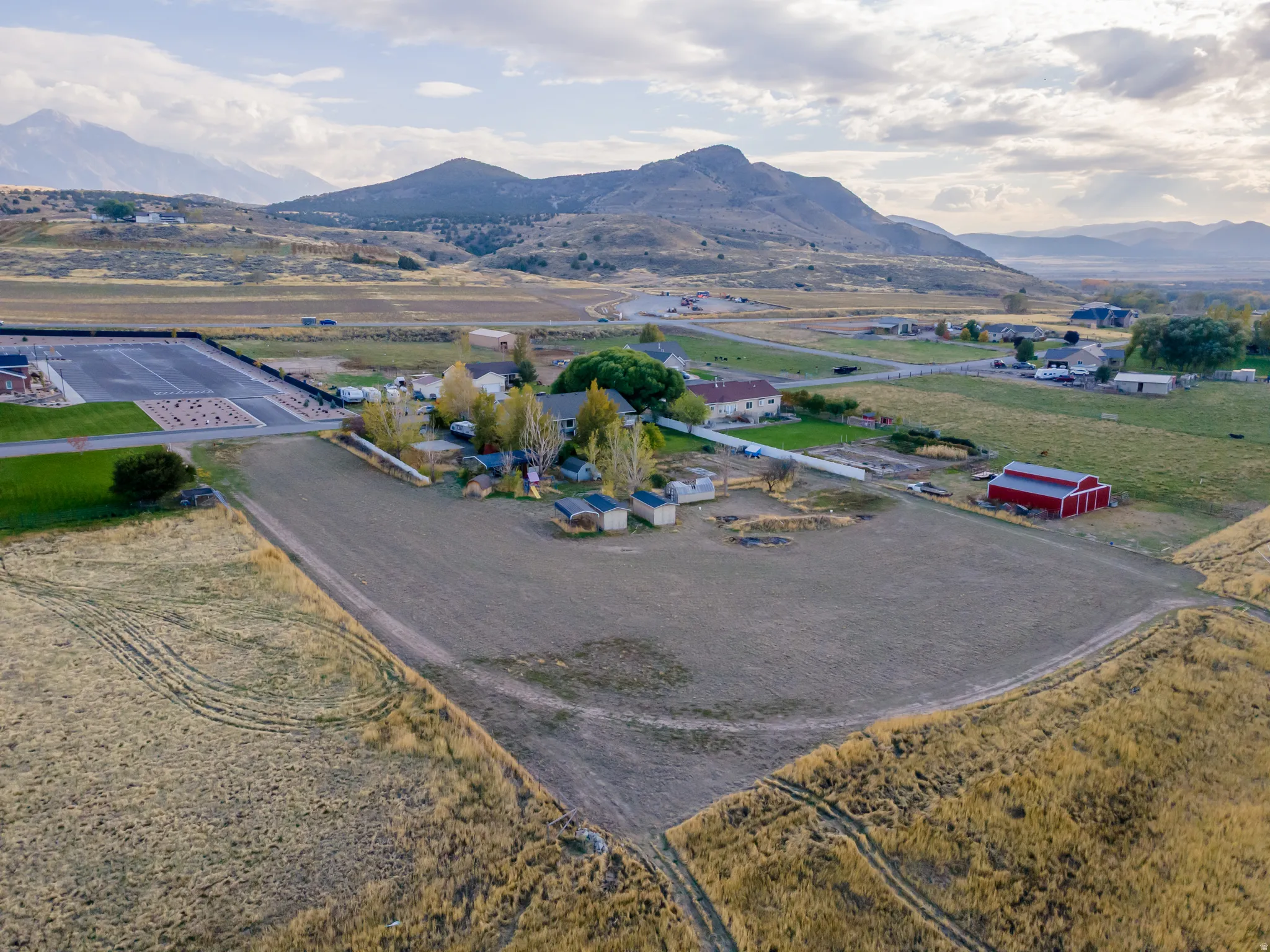 Aerial overview of property's location with a mountainous background and rural landscape