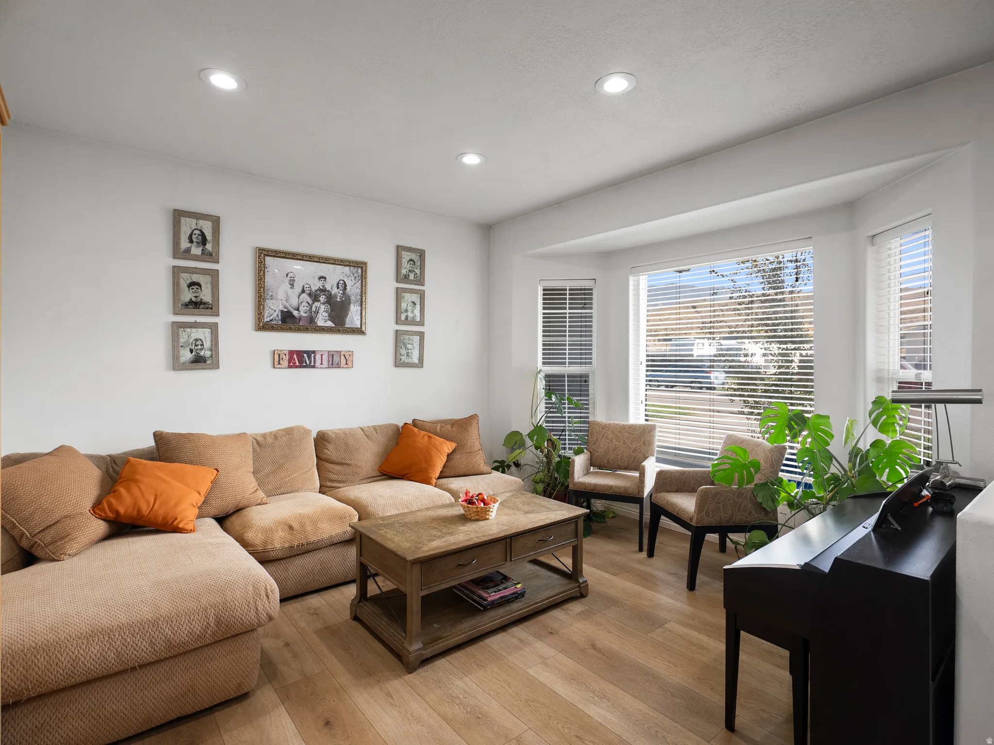 Living area featuring light wood-style floors and recessed lighting