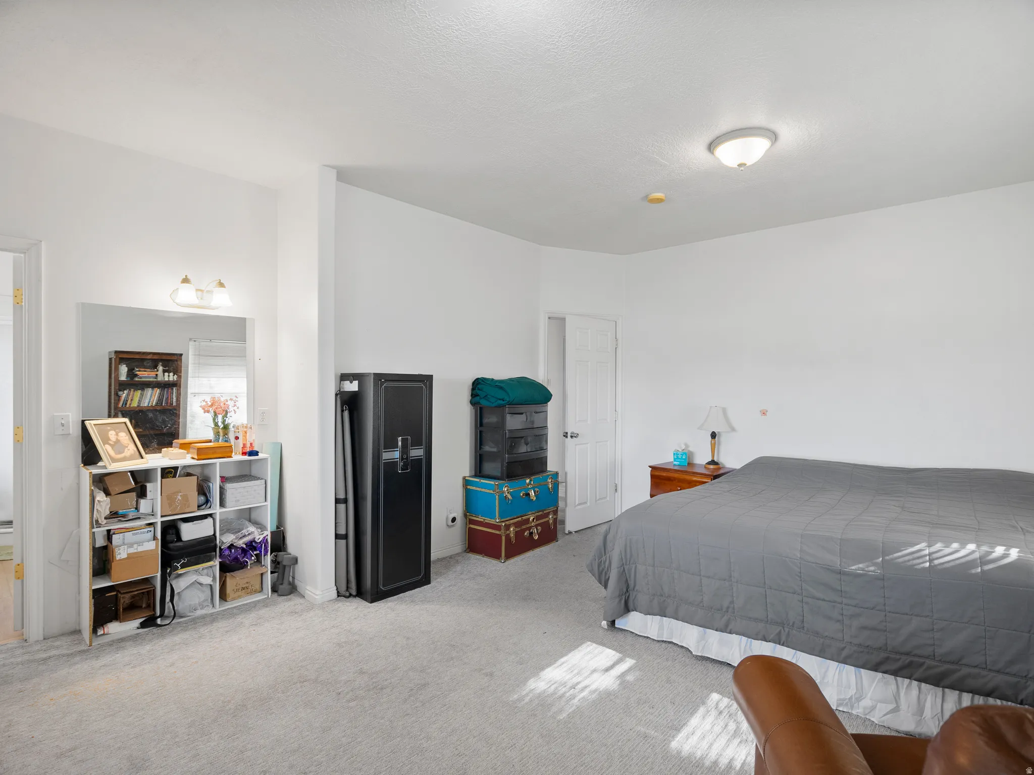 Bedroom featuring light carpet