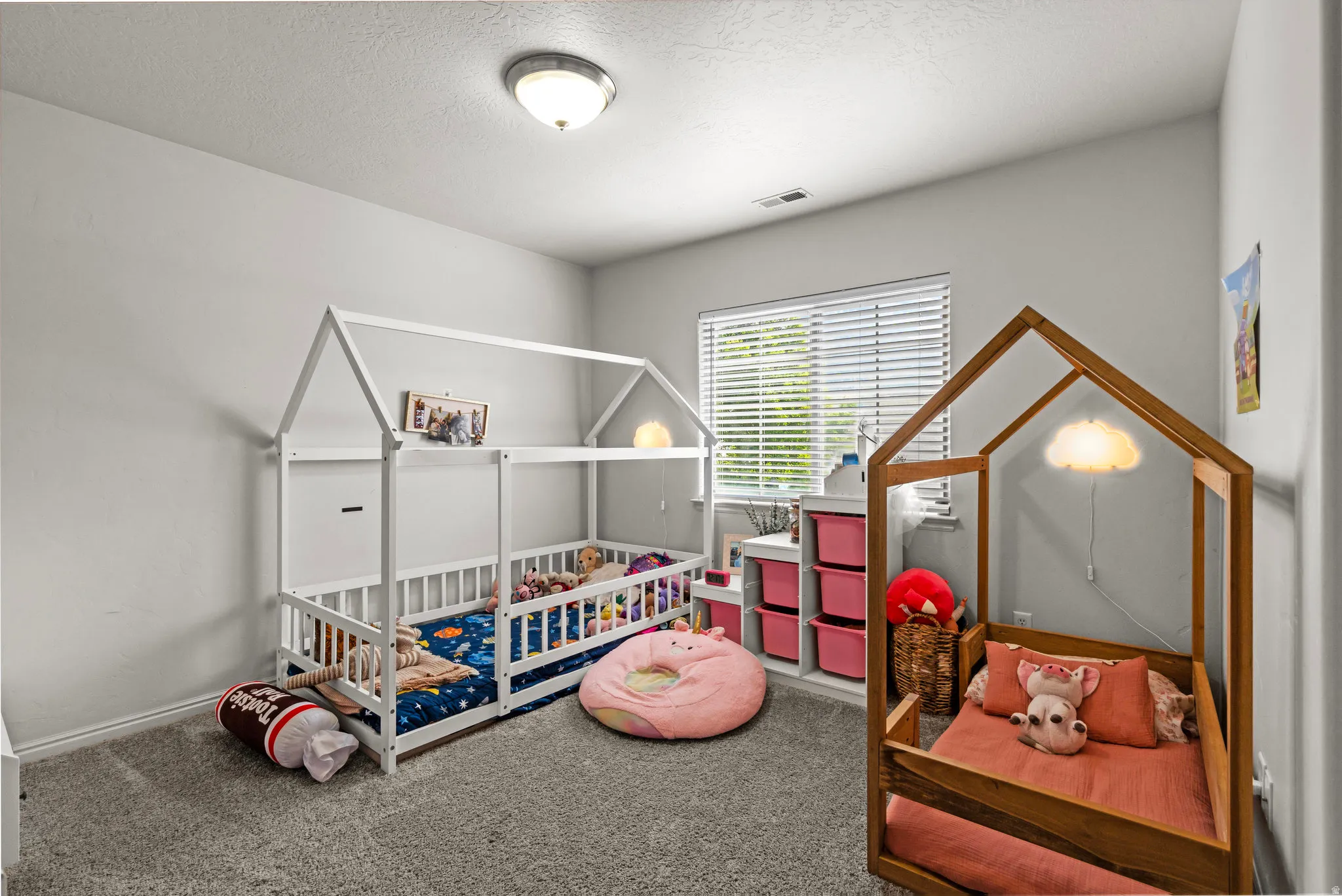Carpeted bedroom with a textured ceiling and baseboards