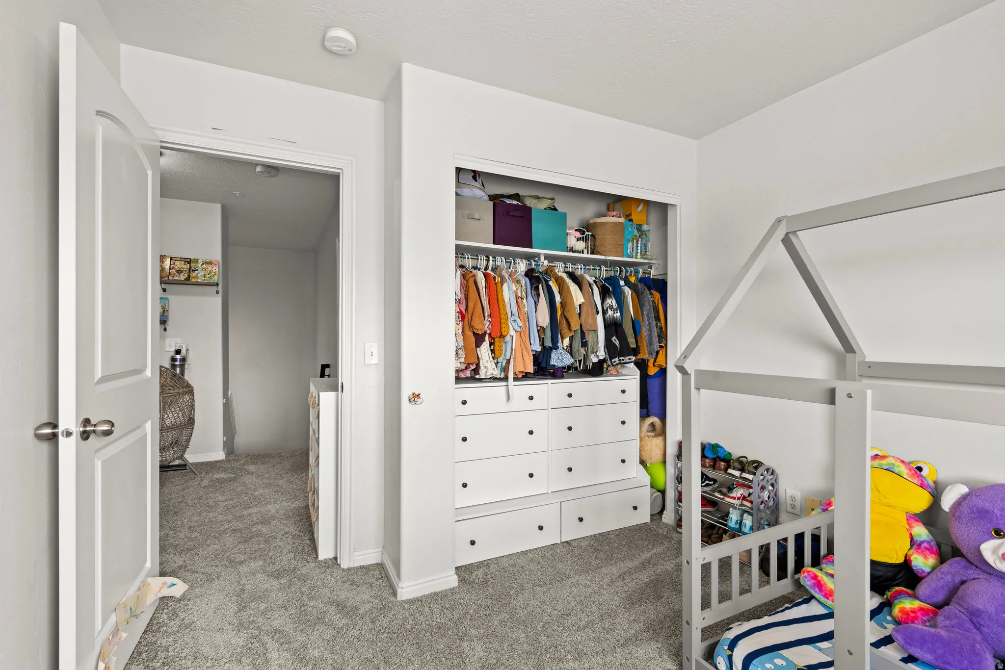 Carpeted bedroom featuring a closet and baseboards
