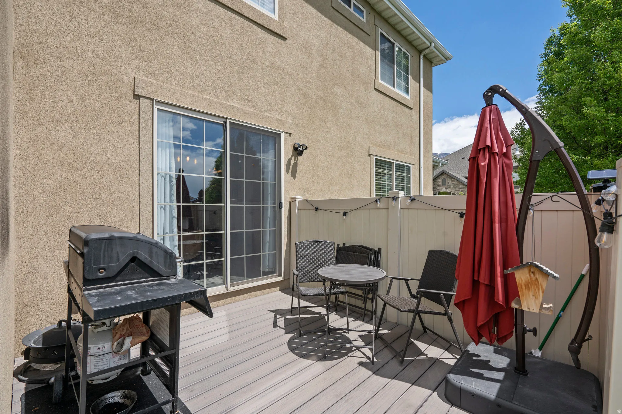 Wooden deck featuring a grill and outdoor dining space