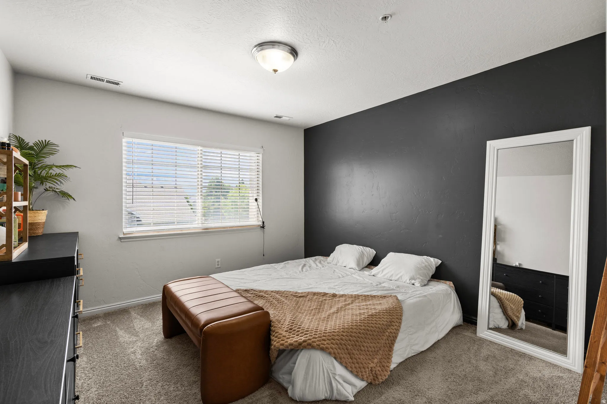 Bedroom with carpet and a textured ceiling