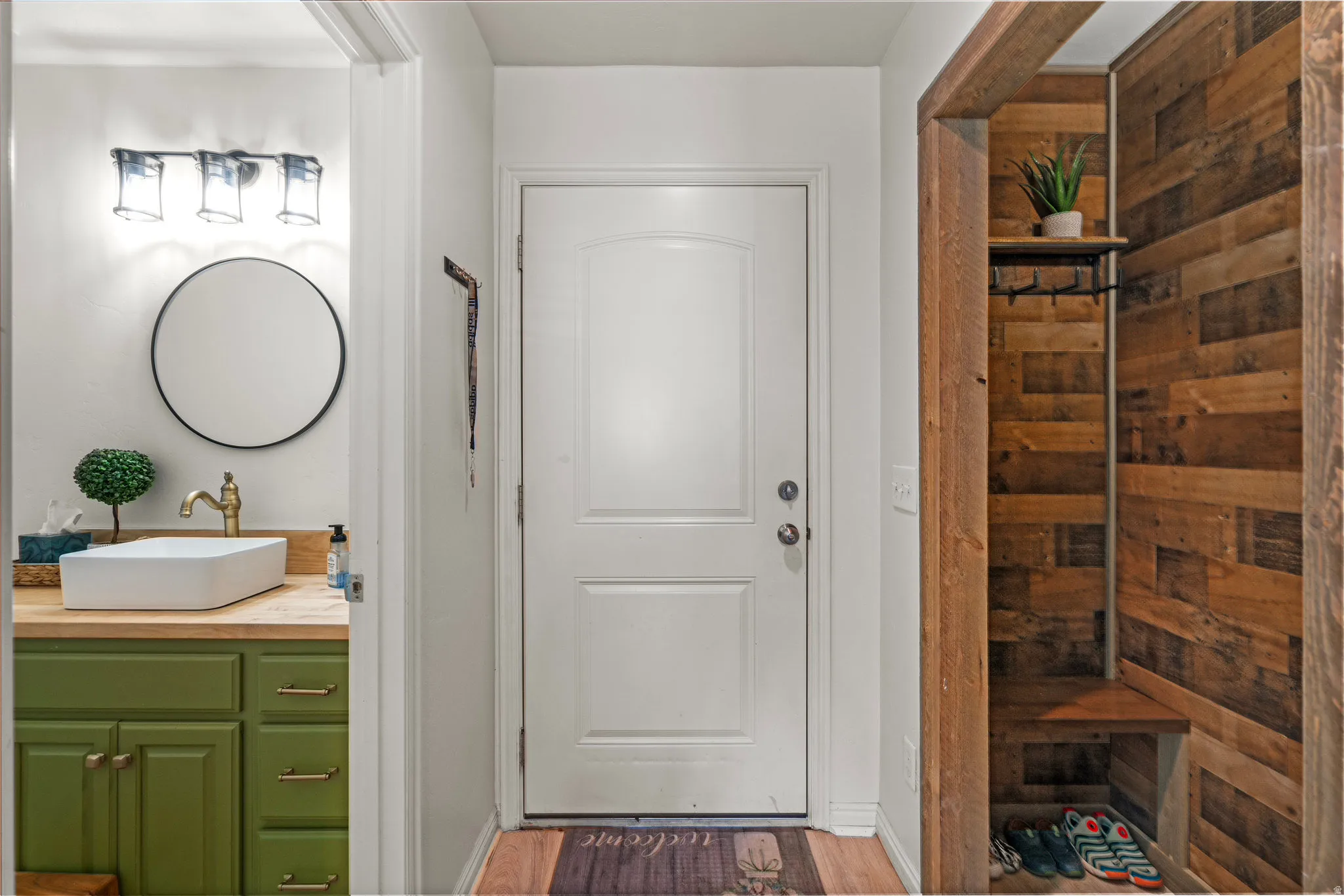 Full bath with vanity and light wood-style floors