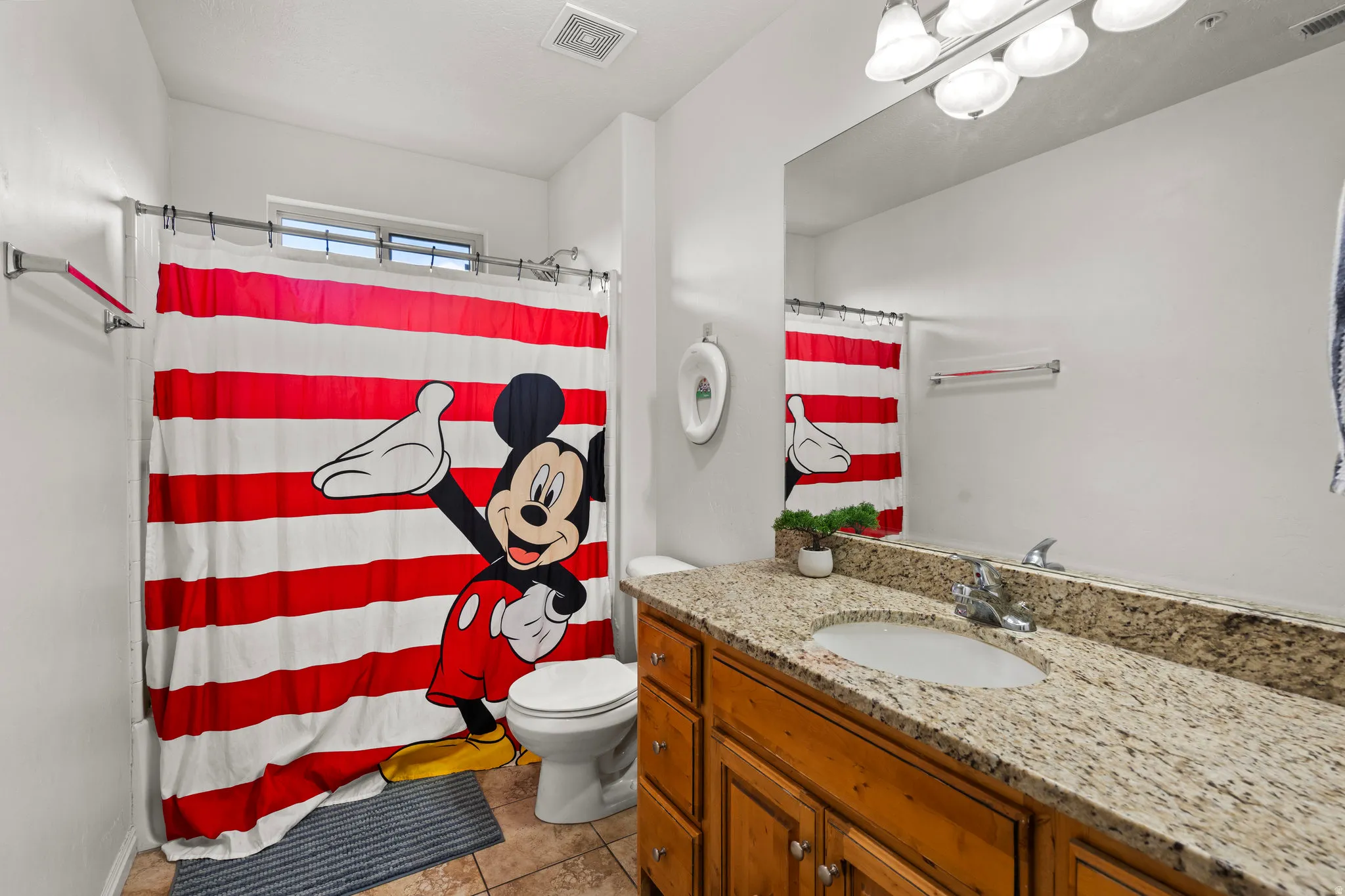 Bathroom featuring vanity, curtained shower, and light tile patterned floors