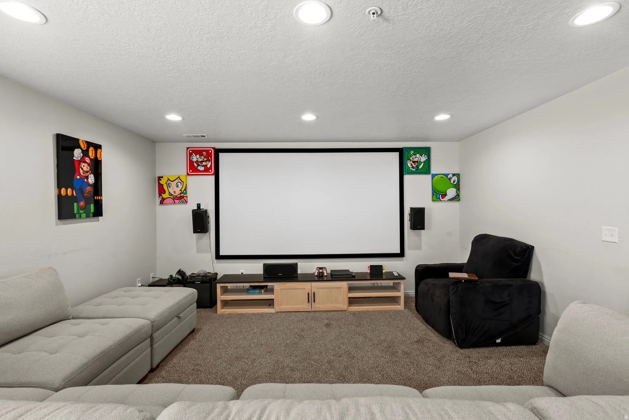 Cinema with carpet flooring, recessed lighting, and a textured ceiling