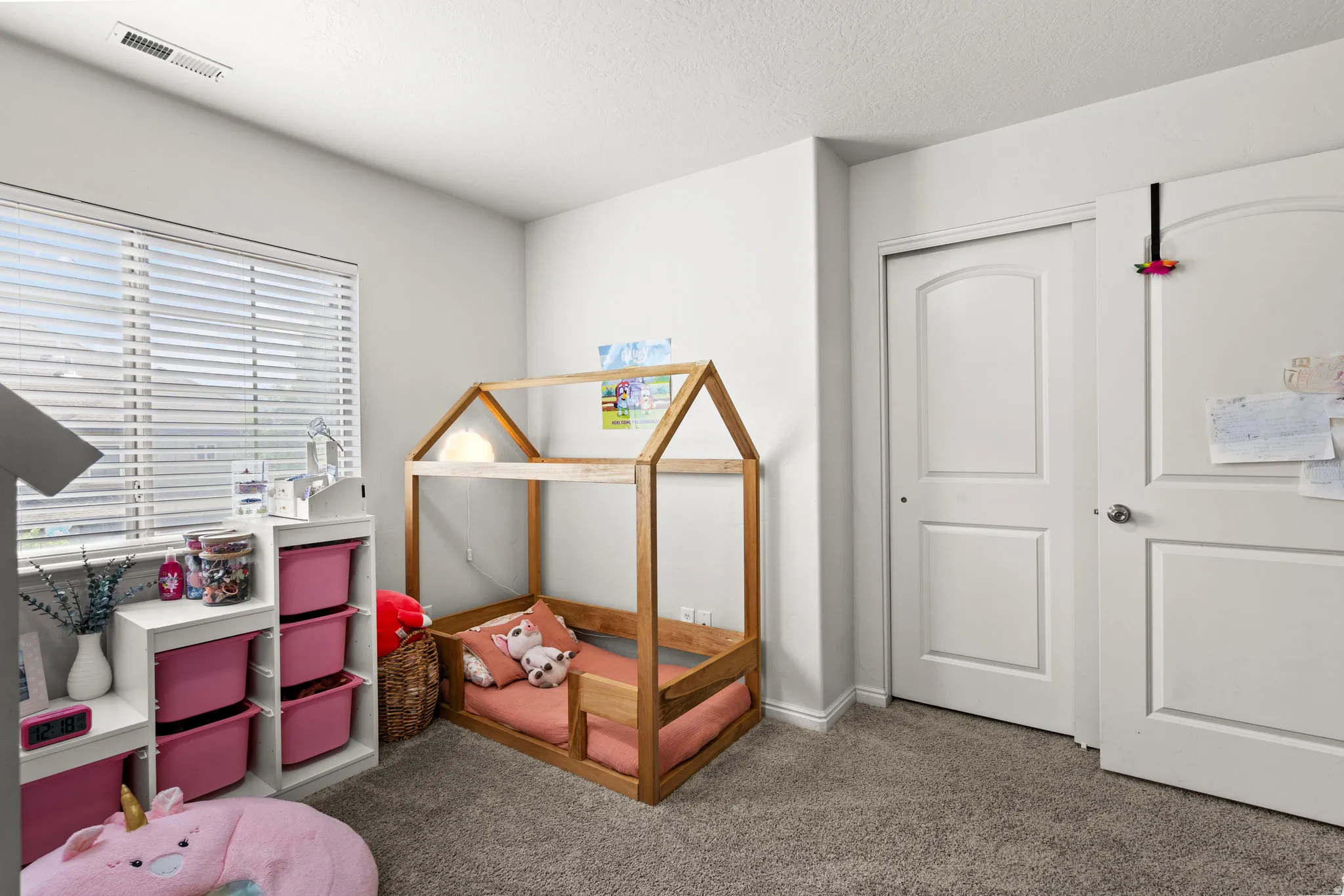 Bedroom featuring carpet flooring, a closet, and a textured ceiling