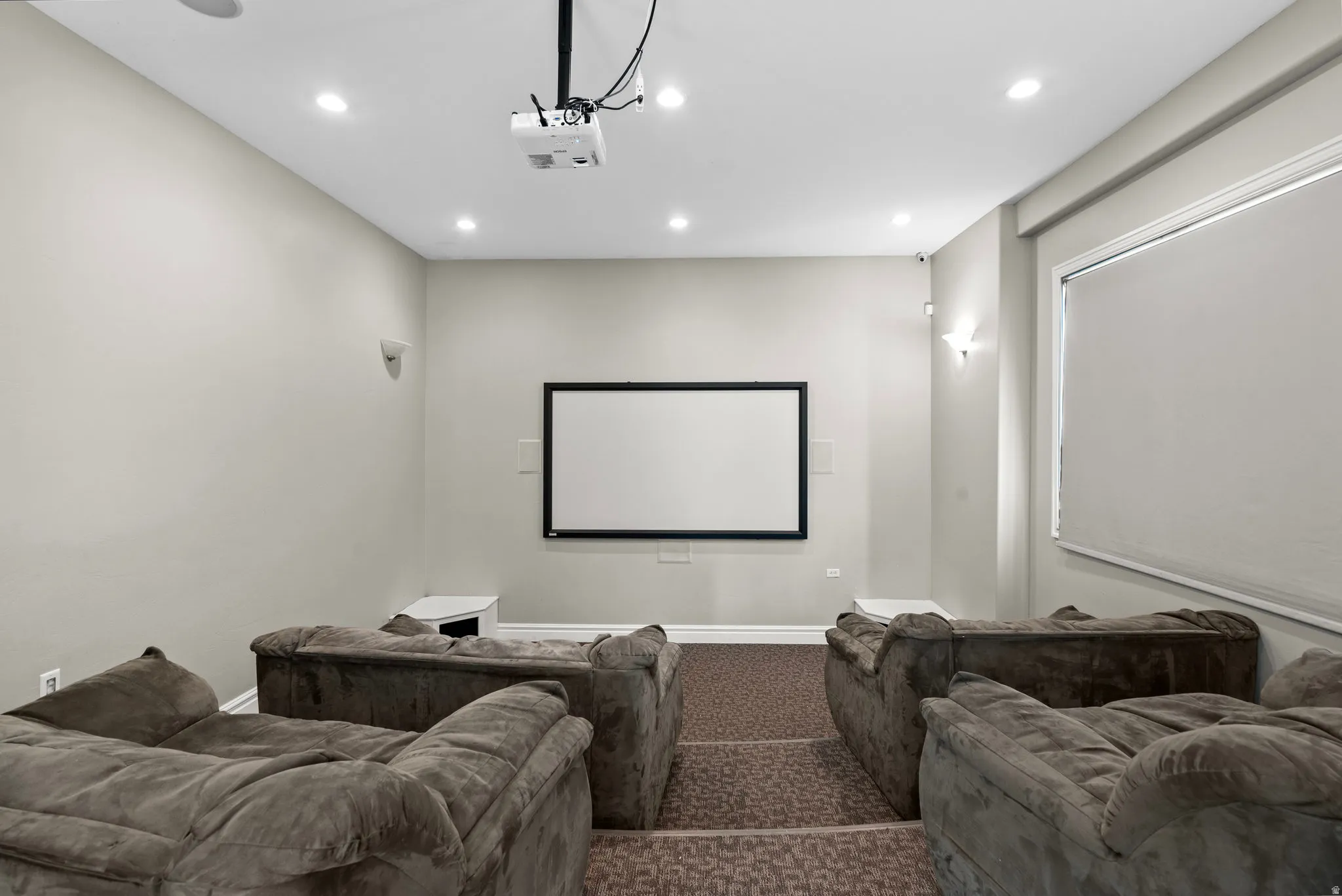 Home theater with recessed lighting and carpet