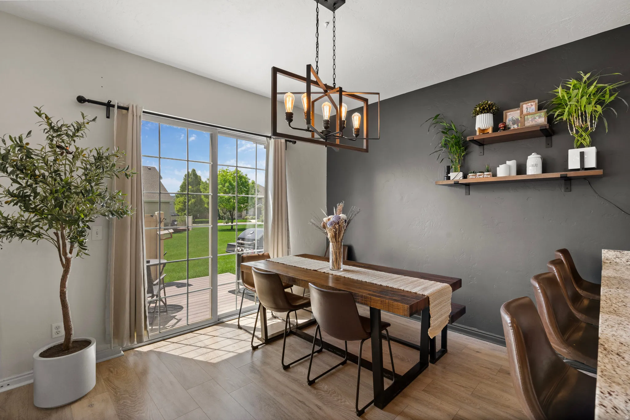 Dining area with light wood-type flooring and a chandelier