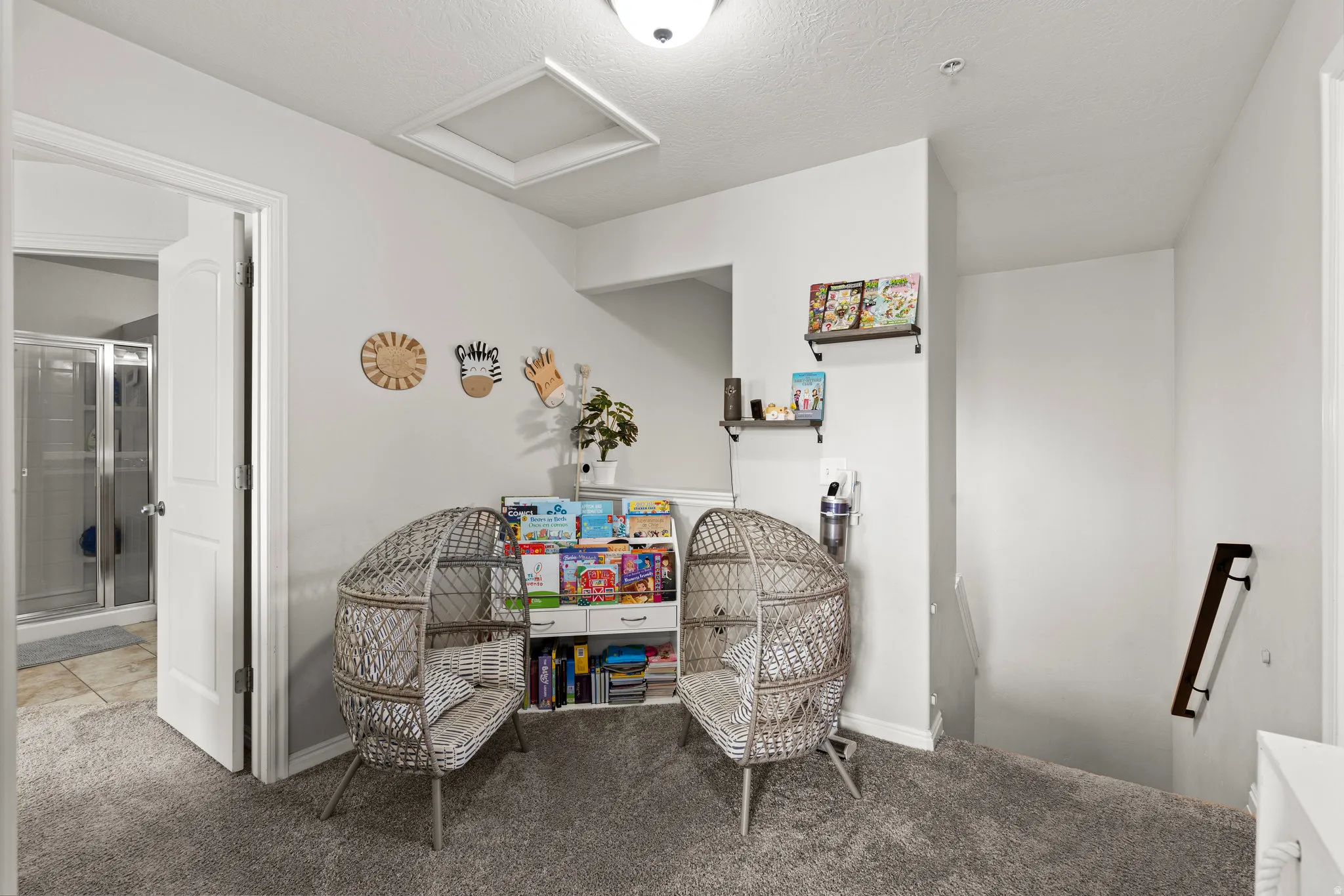 Sitting room featuring carpet flooring and an upstairs landing