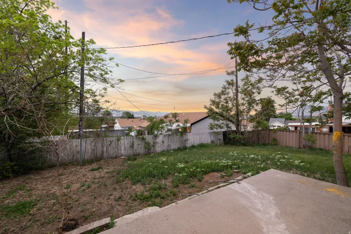 Fenced backyard with a patio area