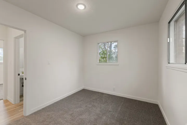 Unfurnished room with carpet flooring and baseboards