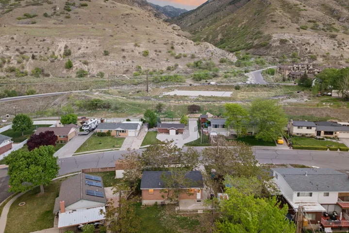 Aerial perspective of suburban area featuring a mountain backdrop