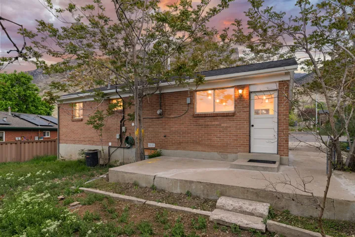 Back of house featuring brick siding
