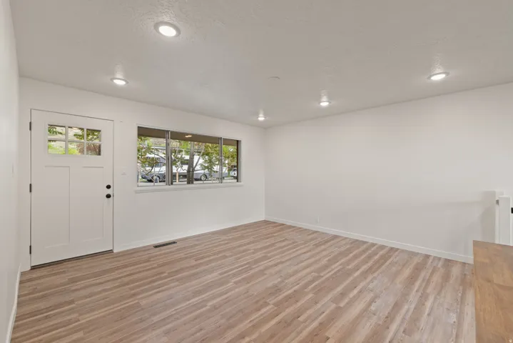 Foyer entrance featuring light wood-style floors, a textured ceiling, and recessed lighting