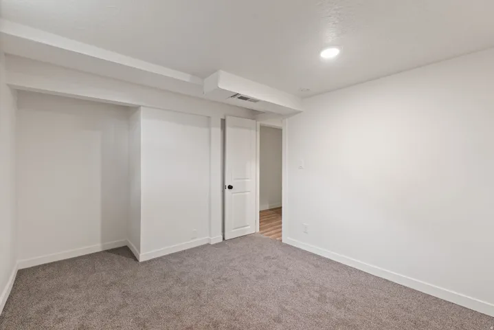 Finished below grade area with carpet floors and a textured ceiling