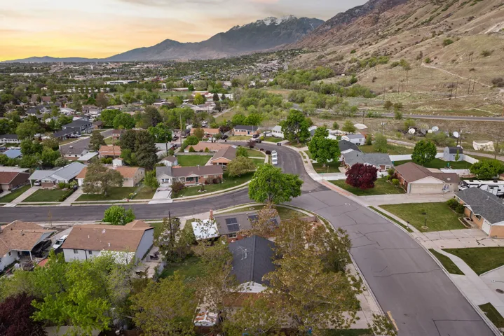 Aerial overview of property's location with a mountainous background and nearby suburban area