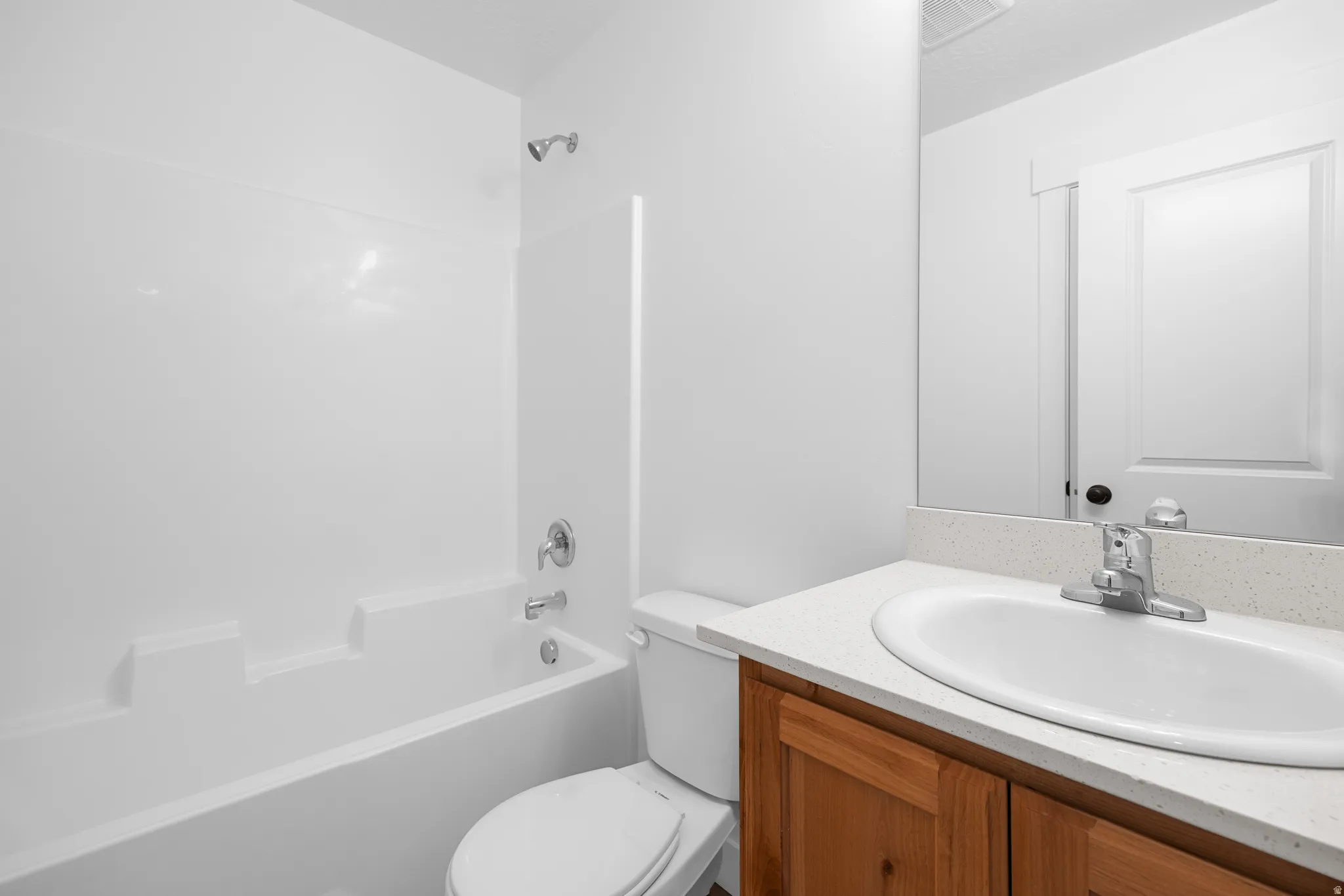 Bathroom with vanity and shower / washtub combination