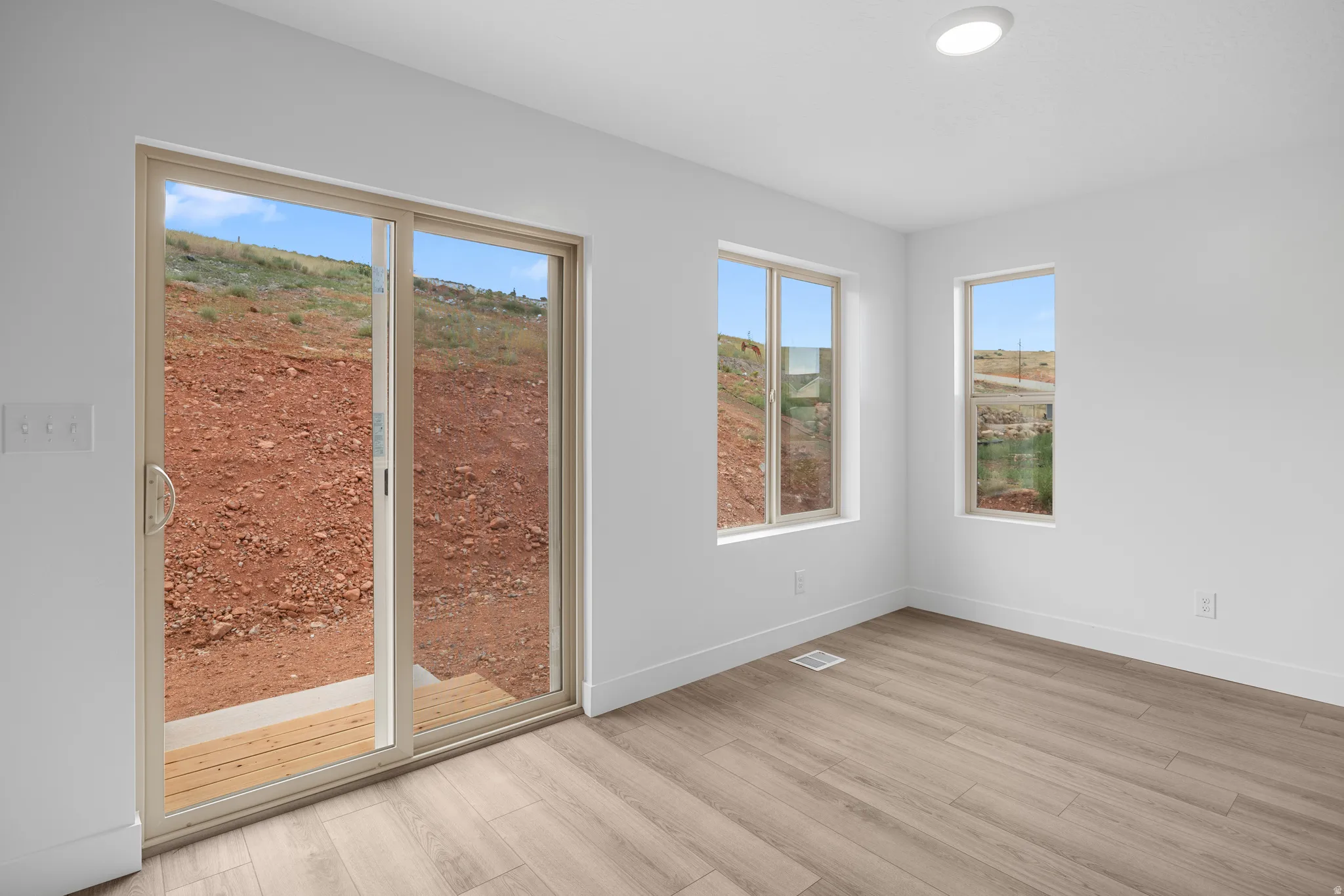 Unfurnished room with baseboards and light wood-style flooring