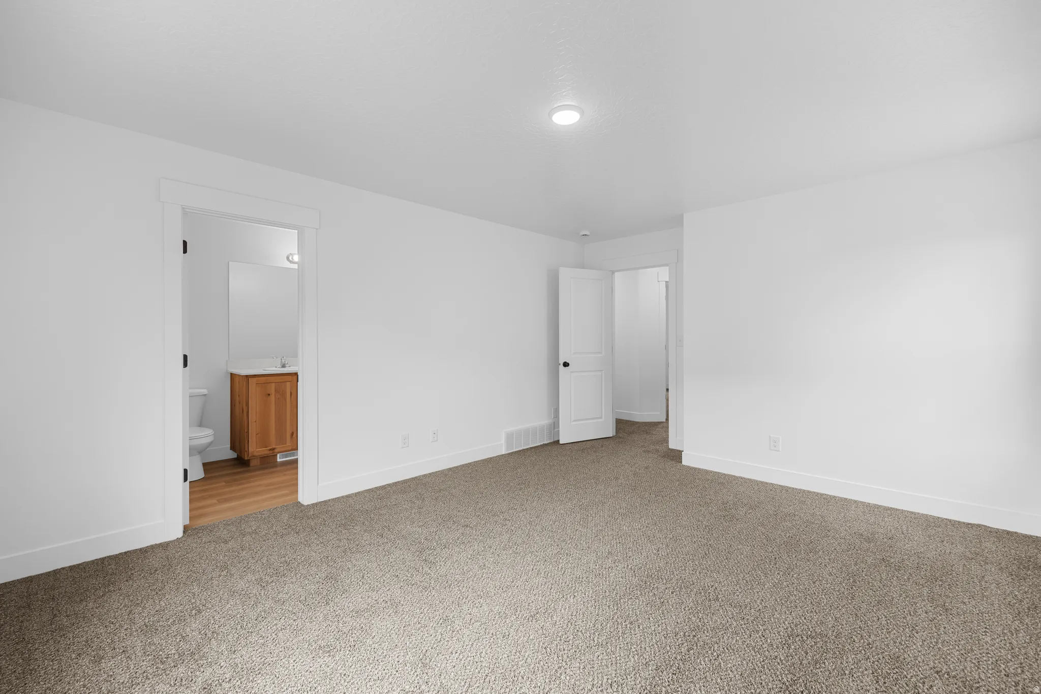 Carpeted empty room featuring baseboards