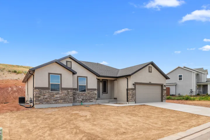 View of front of home featuring stone siding, stucco siding, concrete driveway, and an attached garage
