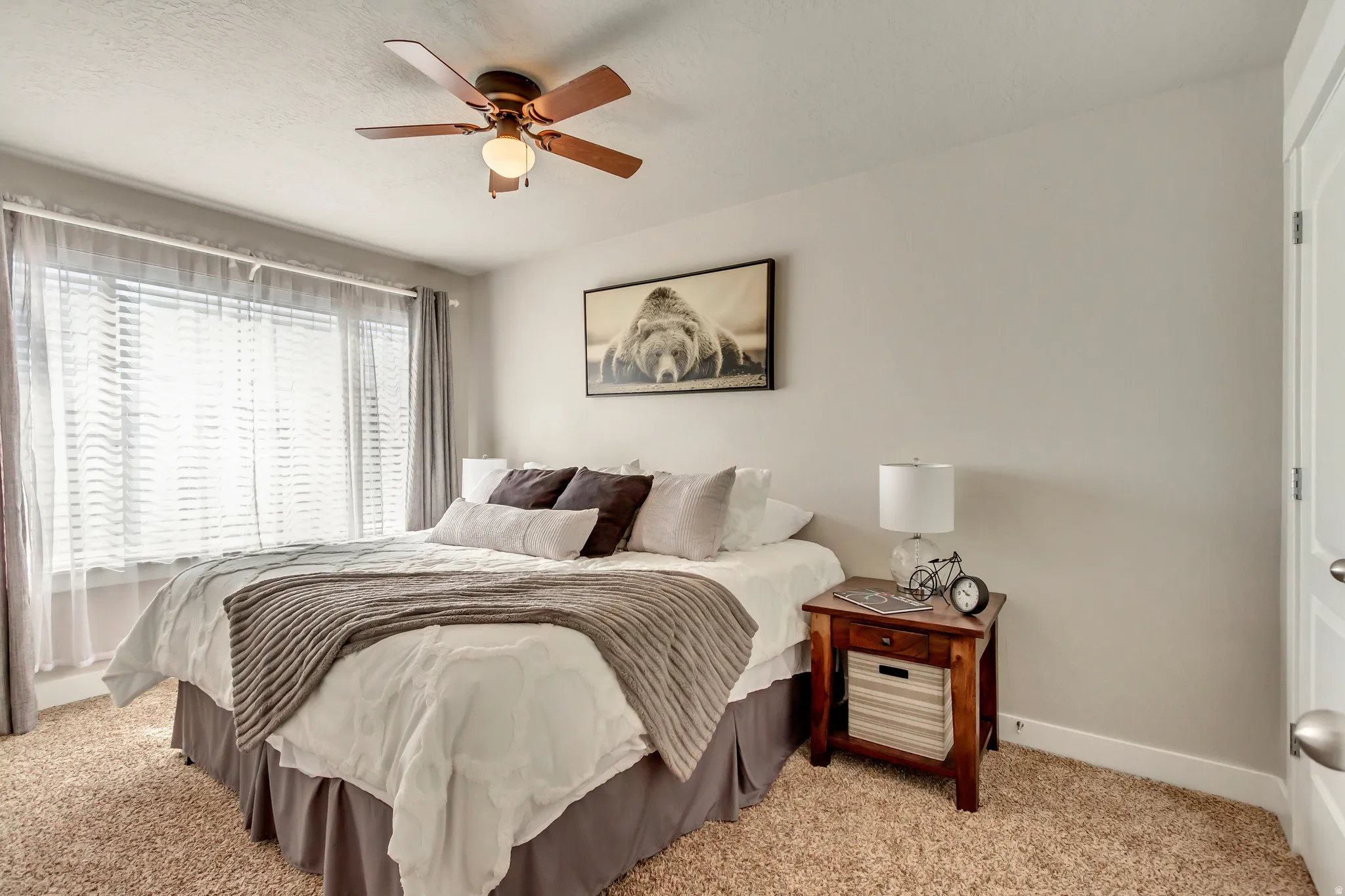 Bedroom featuring light colored carpet and ceiling fan