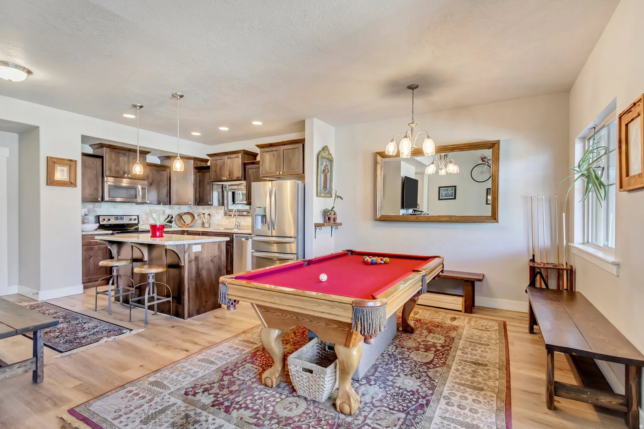 Playroom featuring light wood-style flooring, billiards table, and a chandelier