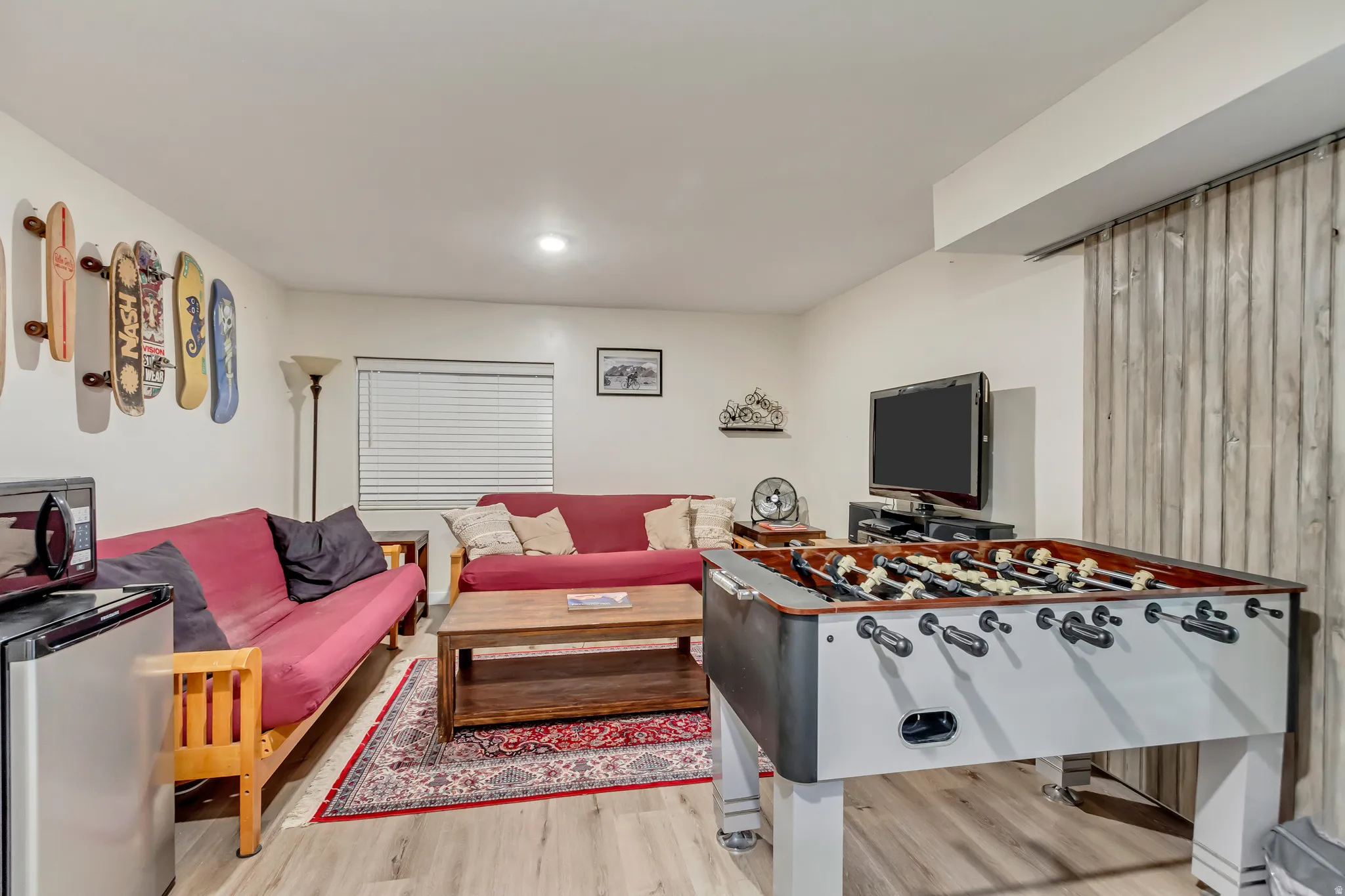 Rec room with light wood-type flooring