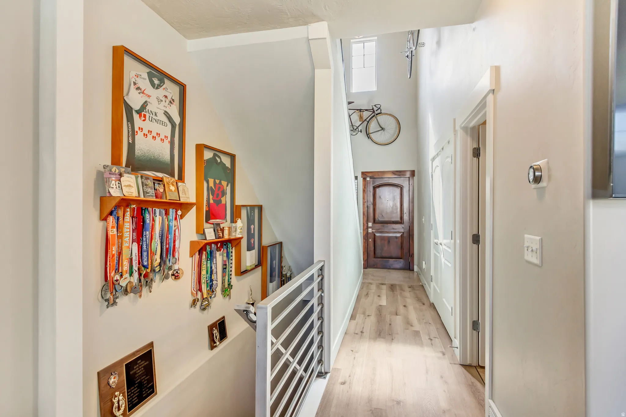 Hallway featuring light wood-type flooring and baseboards