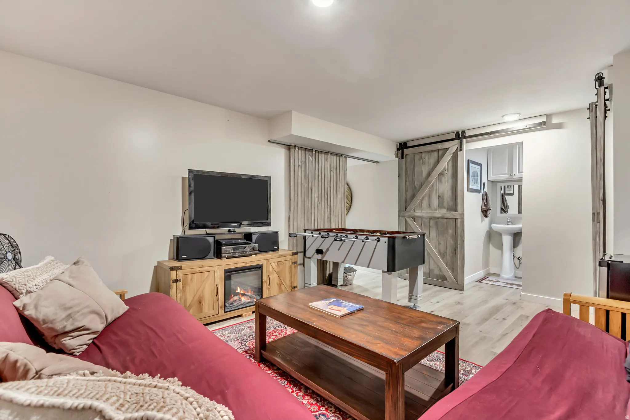 Living room featuring a barn door and light wood-type flooring