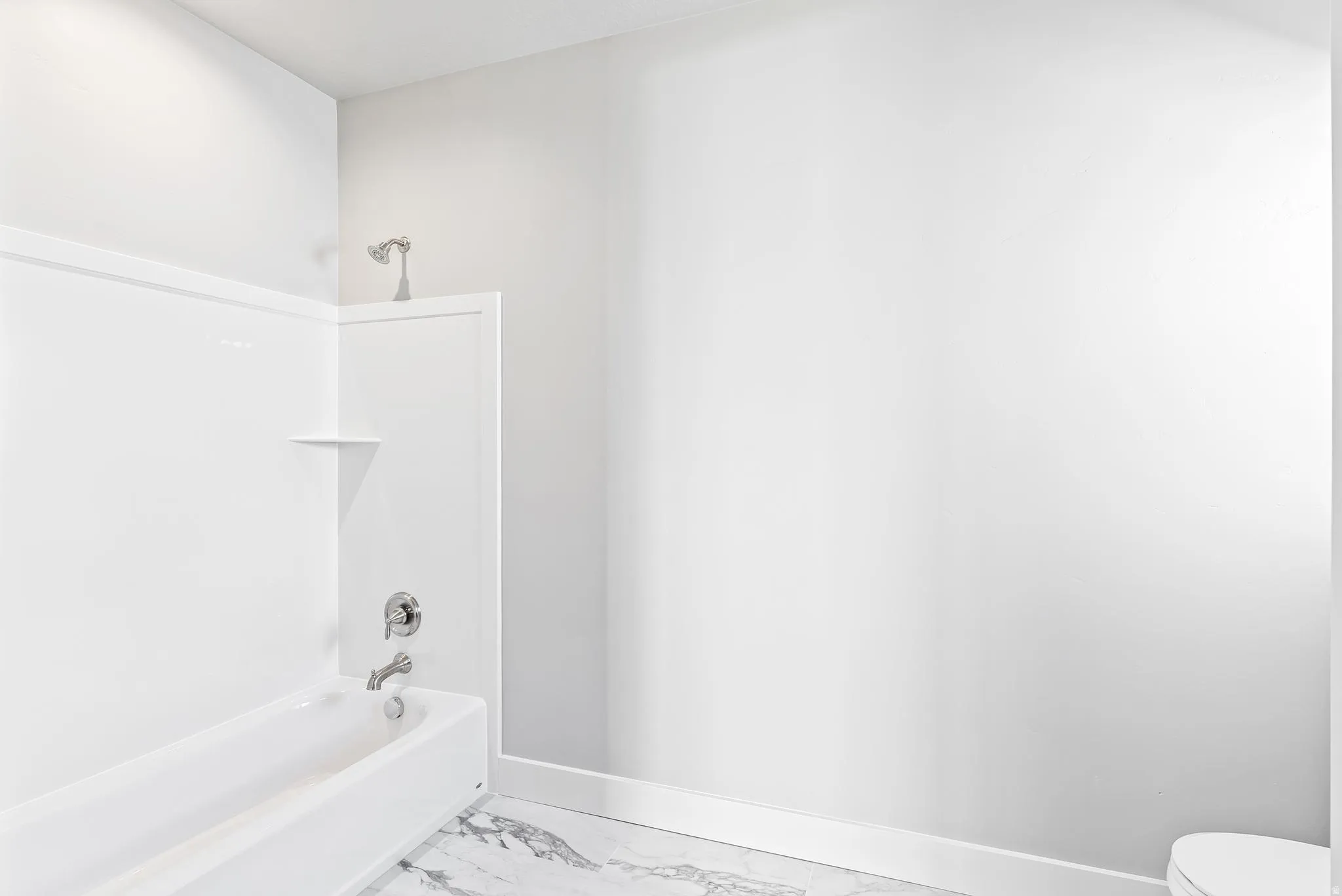 Full bath featuring bathtub / shower combination and light marble finish flooring
