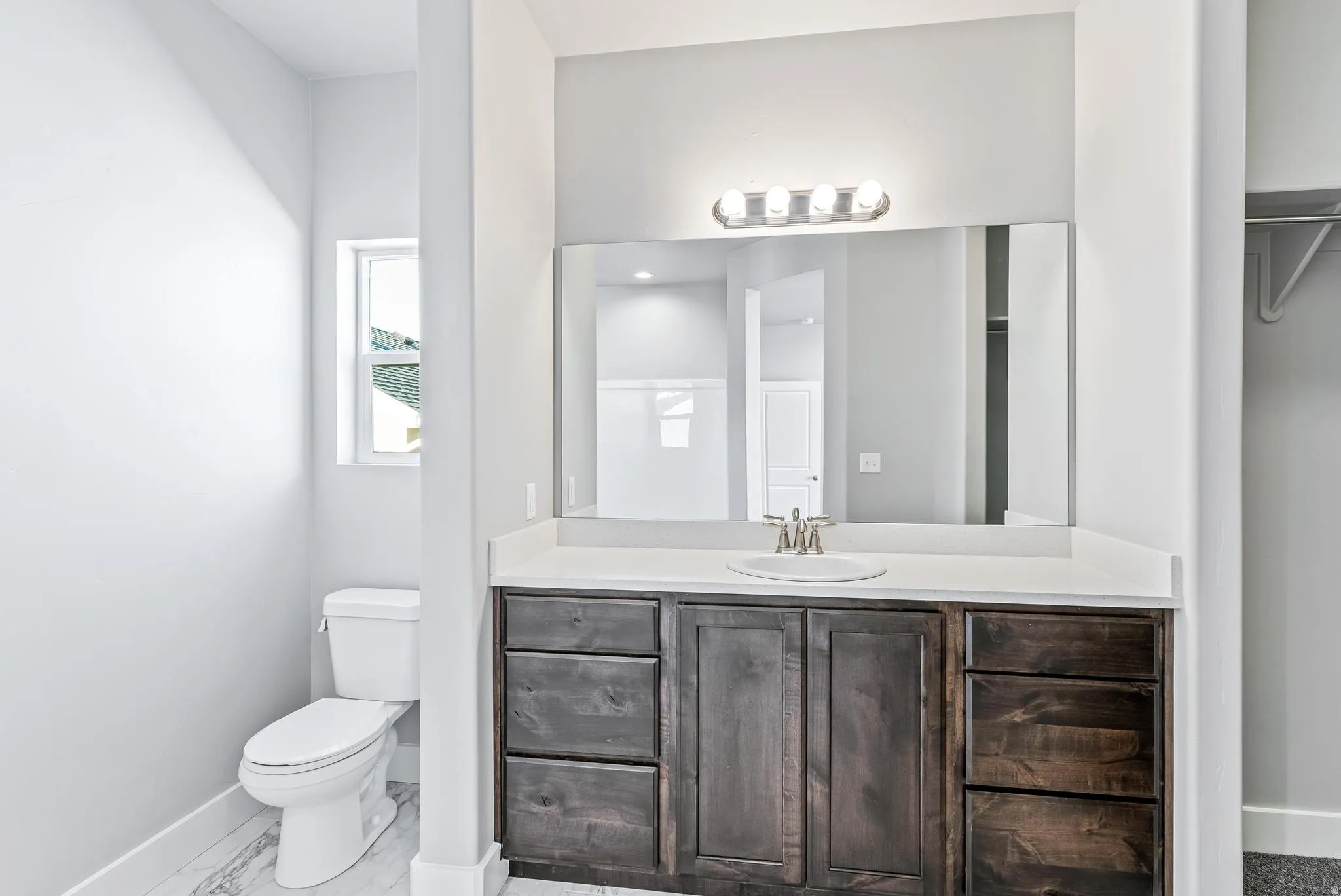 Full bathroom featuring vanity and light marble finish floors