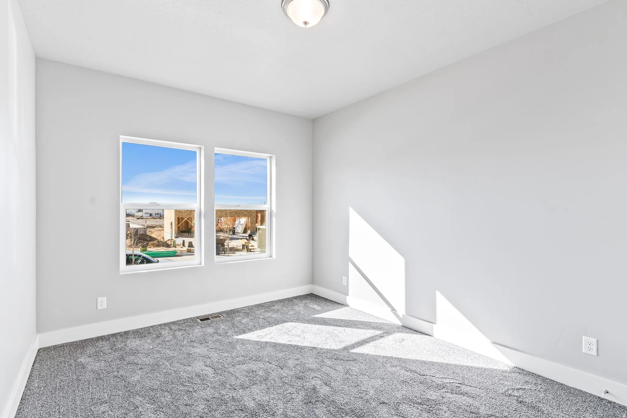 Carpeted empty room featuring baseboards