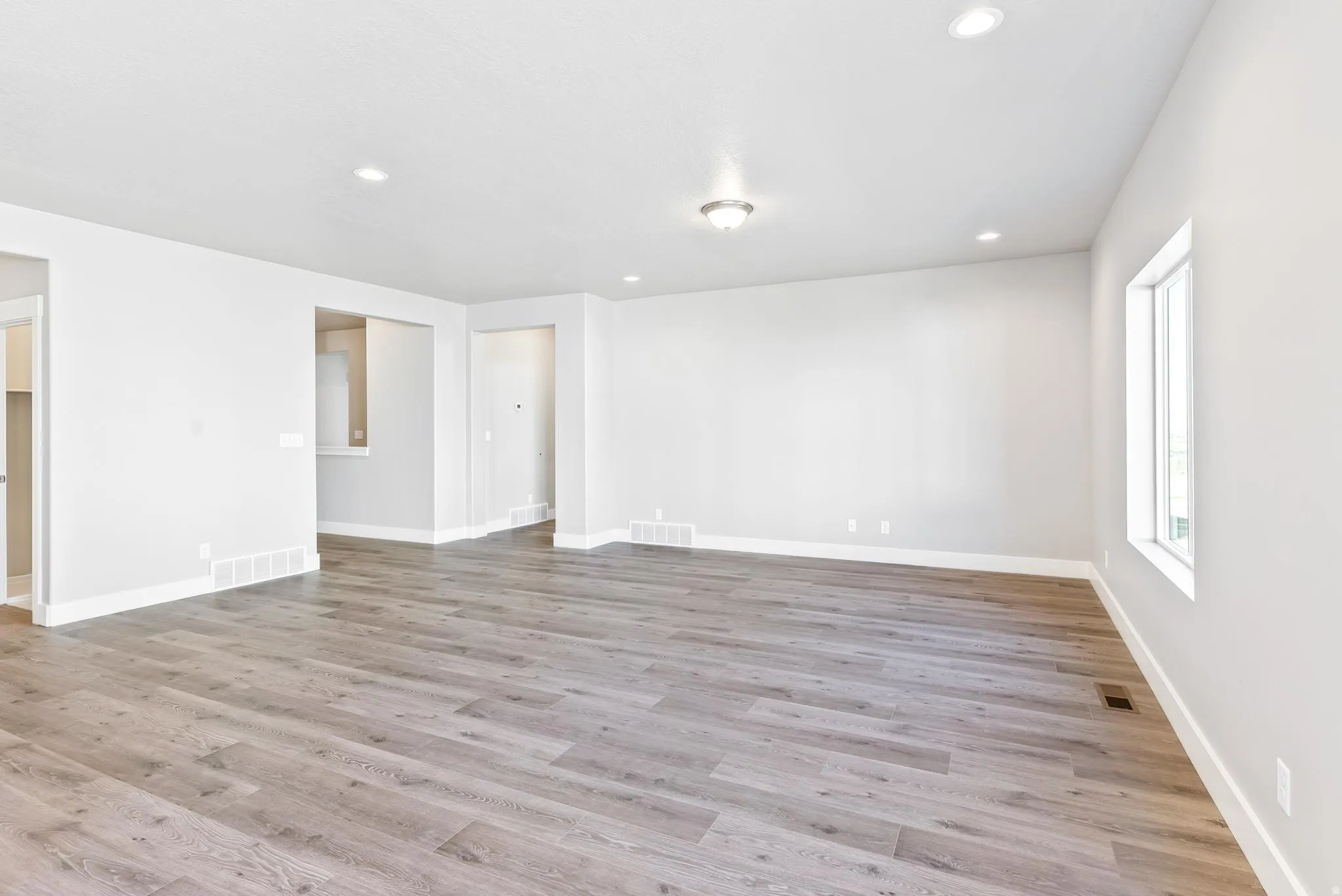 Spare room with light wood-type flooring and recessed lighting