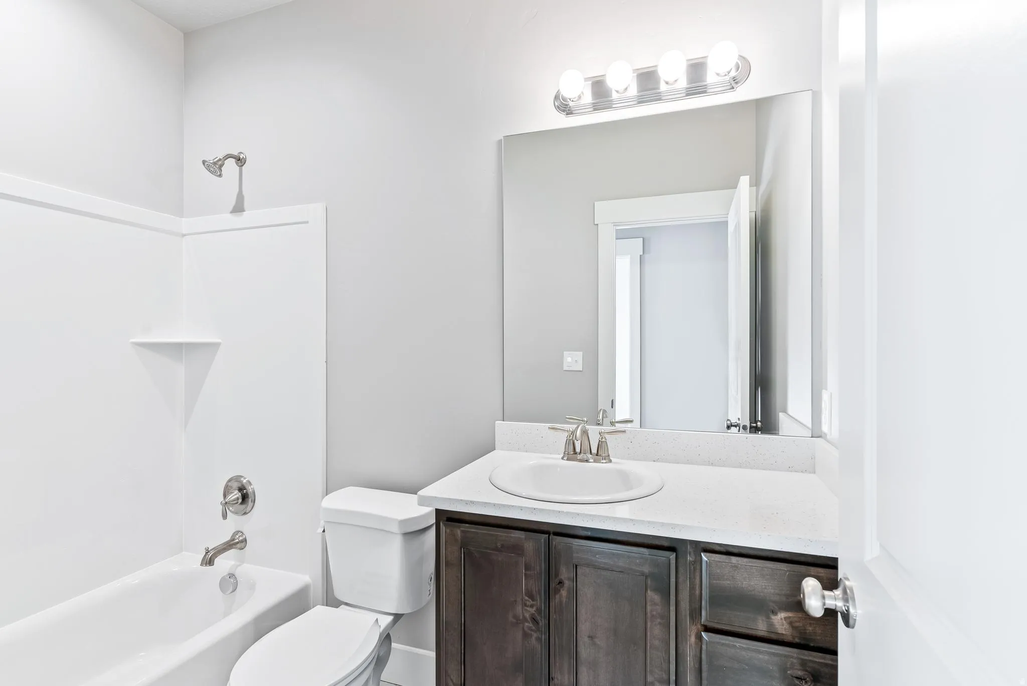 Bathroom featuring vanity and  shower combination