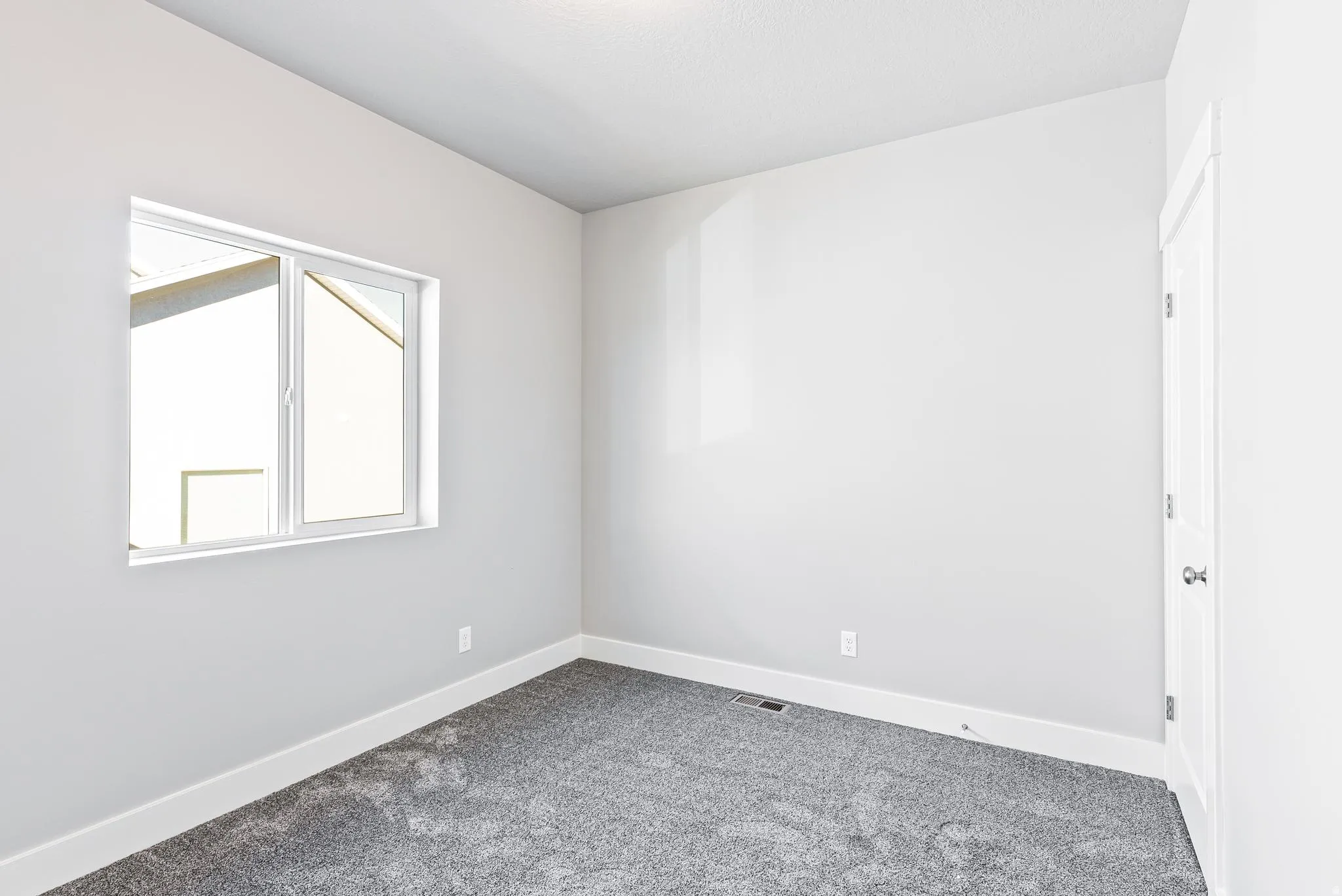 Unfurnished room with baseboards and carpet floors