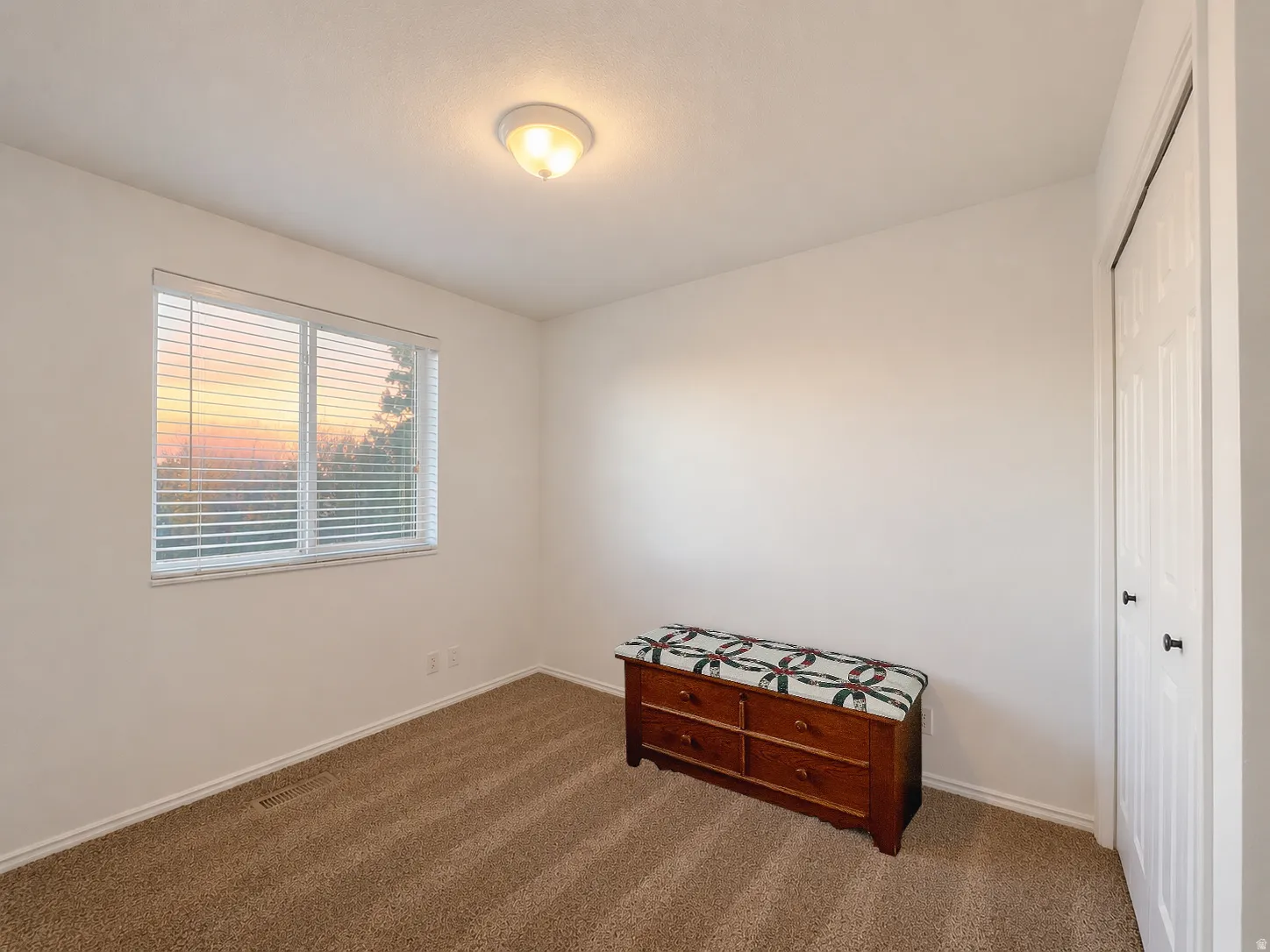 Bedroom with a closet and dark carpet