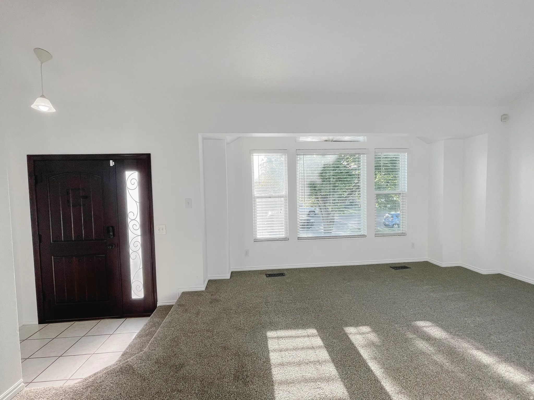Entrance foyer with new carpet colored carpet and updated front door.