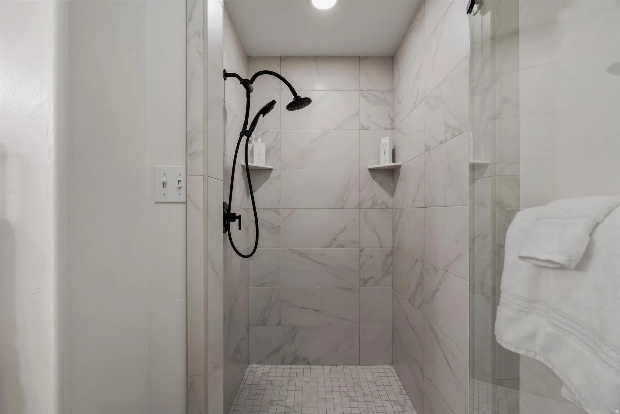 Full bath featuring a shower stall
