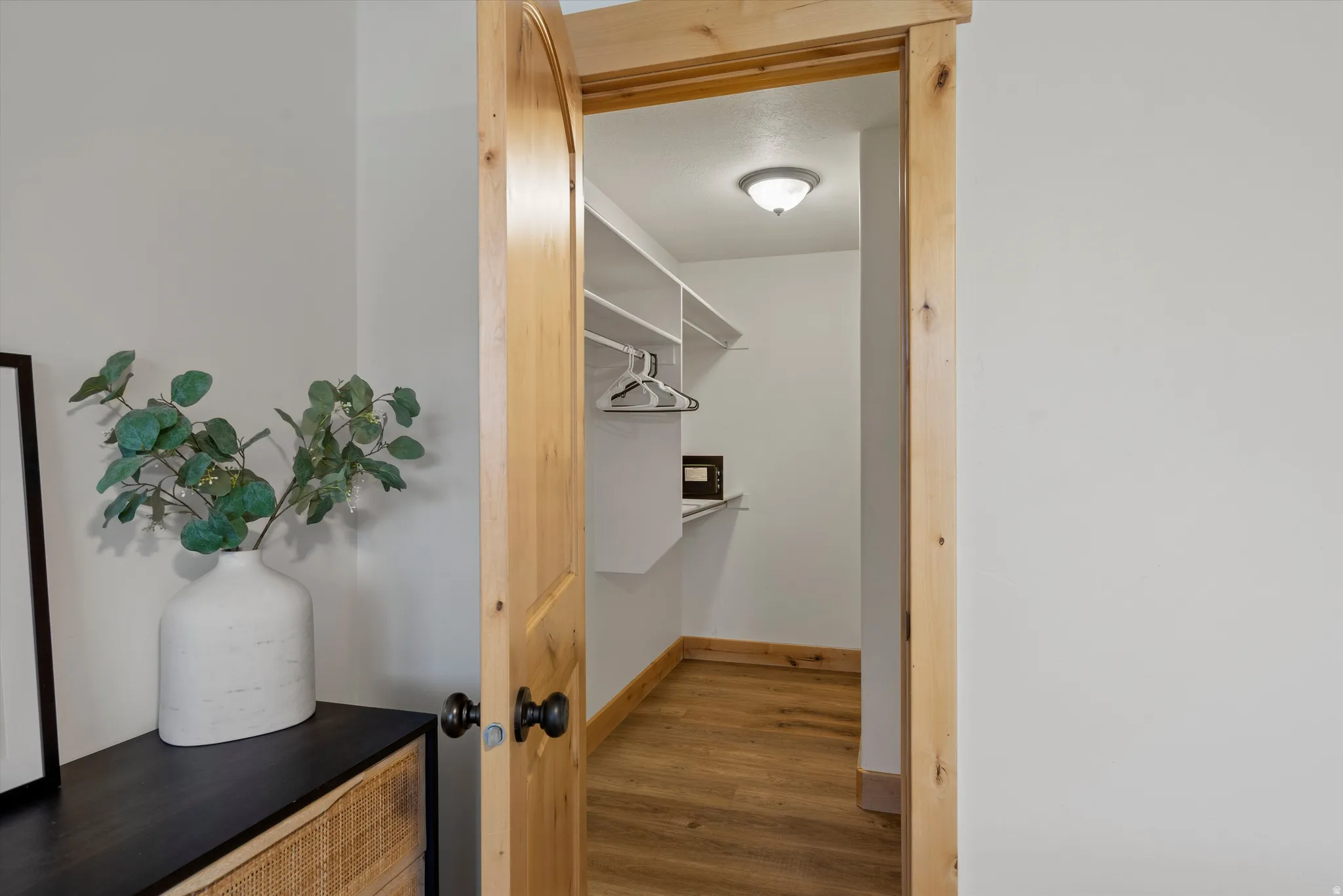 Walk in closet featuring wood finished floors