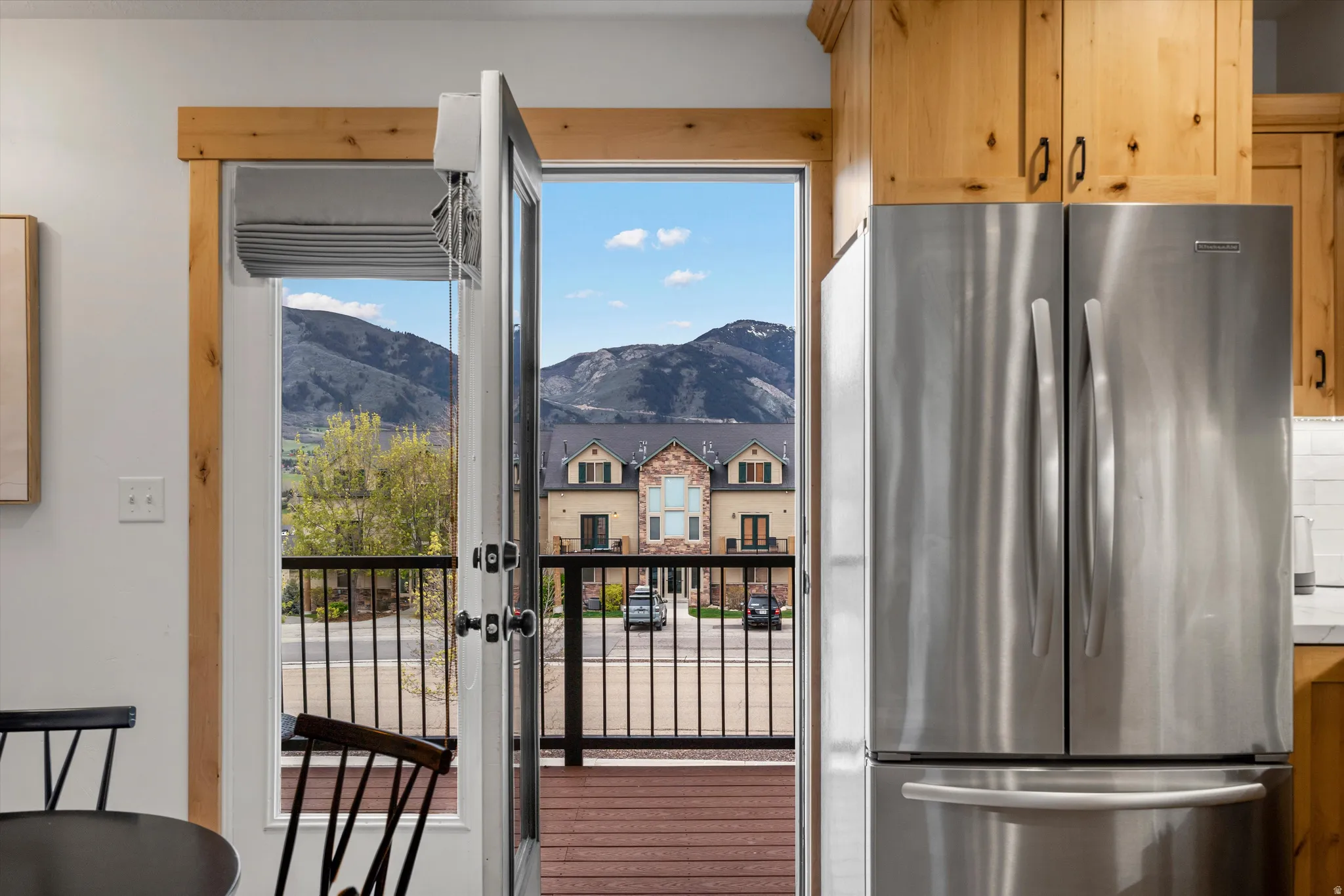 Kitchen with freestanding refrigerator, a mountain view, and light wood finish cabinets