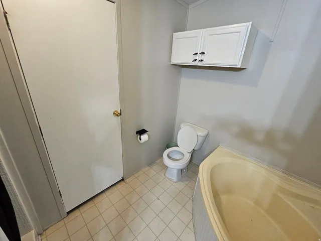 Bathroom featuring a garden tub and light tile patterned floors