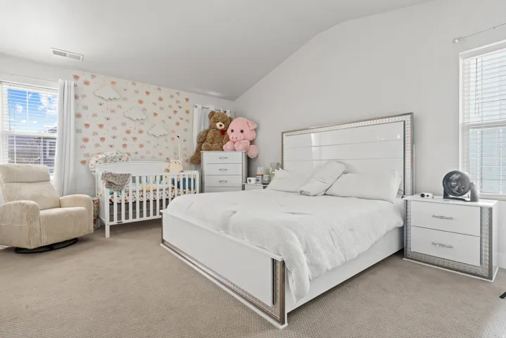 Bedroom featuring carpet and lofted ceiling