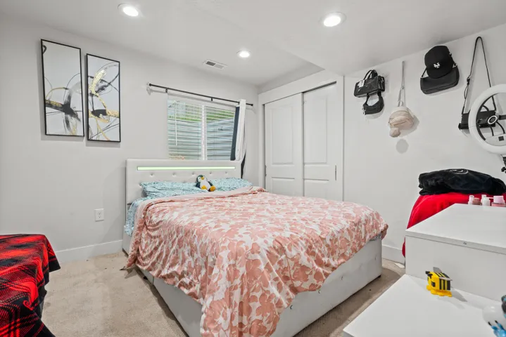 Carpeted bedroom featuring a closet and recessed lighting